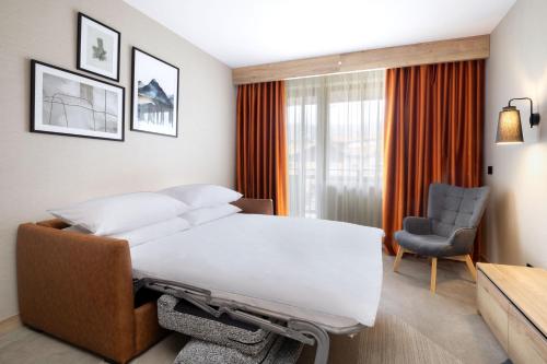 a hospital room with a bed and a chair at Four Points by Sheraton Bansko in Bansko