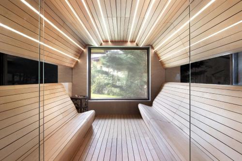 a sauna with a large window and wooden walls at Four Points by Sheraton Bansko in Bansko
