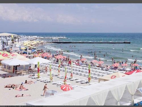 a crowd of people on a beach with umbrellas at Arcadia Adelina in Odesa