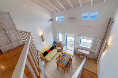 an overhead view of a living room with a couch and a table at ILIOS in Perlopsimades