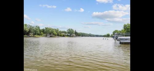 a large body of water with a boat in it at Riverfront Cottage in Fox River Grove