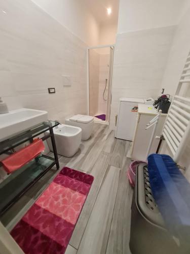 a bathroom with two toilets and a sink and a tub at Villa Mattei Dreams in Rome