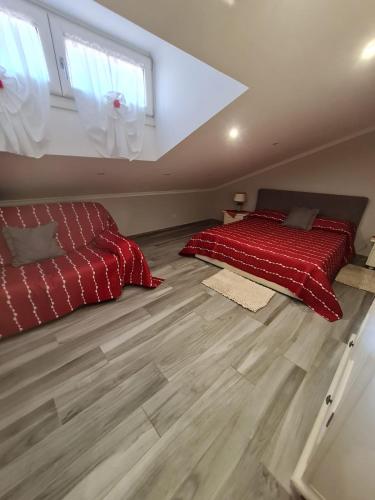 a bedroom with a red bed in a attic at Villa Mattei Dreams in Rome