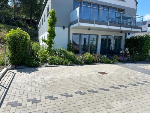 a house with a brick driveway in front of it at Lindenberg Apartments in Wernigerode