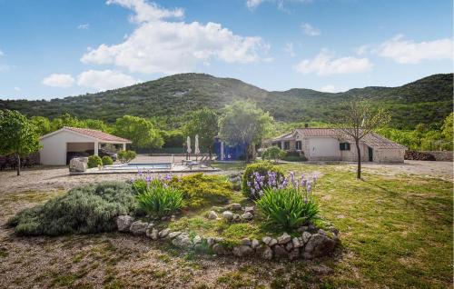 a house with a garden with flowers in the yard at Villa Silentio Dalmatia in Makarska