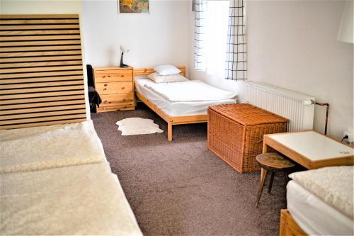 a bedroom with a bed and a dresser and a desk at Chalupa U přátel in Kovářská