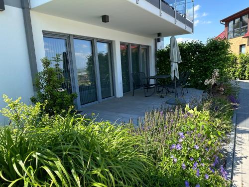 a patio with a table and an umbrella at Lindenberg Apartments in Wernigerode