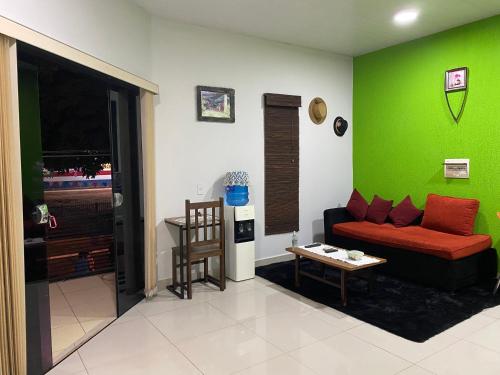 a living room with a couch and a green wall at POSADA DON CANDIDO in San Antonio