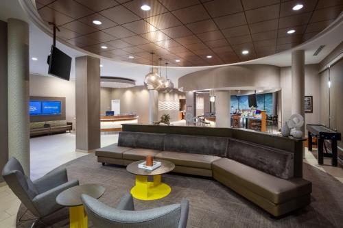 a lobby with a couch and a table and chairs at SpringHill Suites by Marriott Grand Junction Downtown/Historic Main Street in Grand Junction