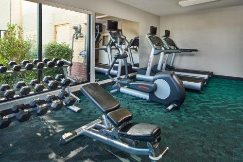 a fitness room with treadmills and elliptical machines at TownePlace Suites by Marriott Garden City in Garden City