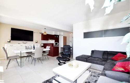 a living room with a couch and a table at Beautiful Apartment In Le Barcarès in Le Barcarès