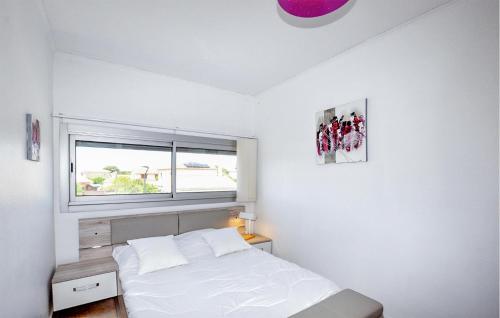 une chambre blanche avec un lit et une fenêtre dans l'établissement Beautiful Apartment In Le Barcarès, au Barcarès