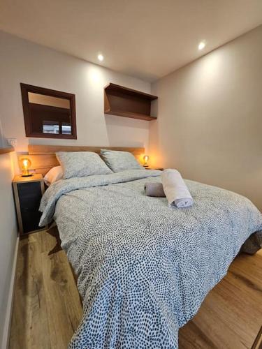 a bedroom with a large bed with two pillows at Le 19 #Terrasse#Parking in Clermont-Ferrand