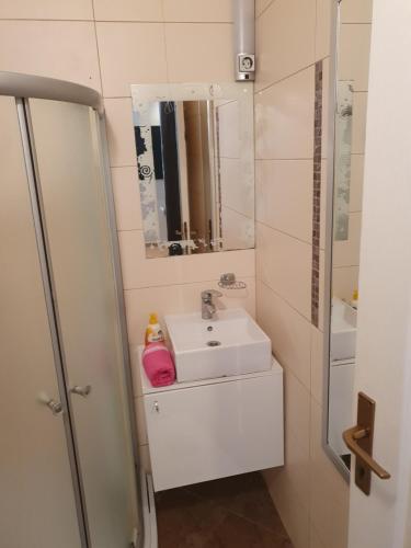 a bathroom with a sink and a mirror at Apartments Eldi in Split