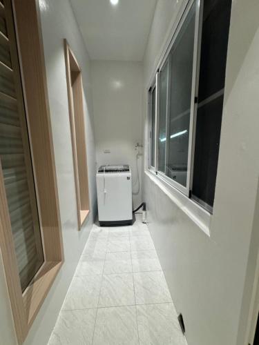 a bathroom with a washer and dryer in a room at SMilE WAVE in Xiaoliuqiu