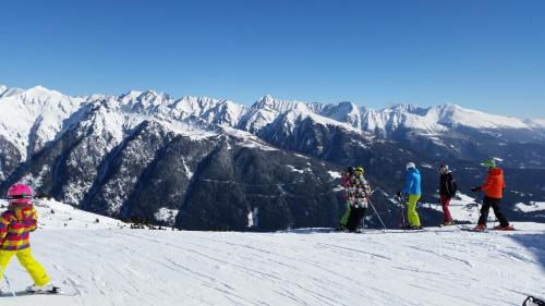 a group of people skiing on a snow covered mountain at Apartments Bogensperger in Mariapfarr