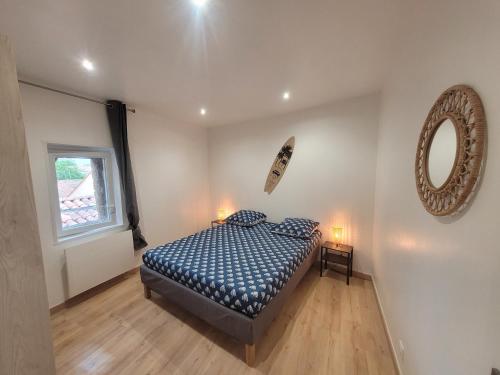 a bedroom with a bed and a mirror on the wall at Le Coquillage in Istres