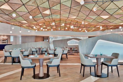 a restaurant with tables and chairs in a room at Sheraton Annaba Hotel in Annaba