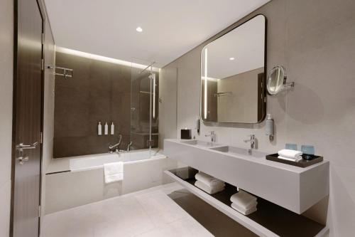 a bathroom with a sink and a mirror at Courtyard by Marriott World Trade Centre, Dubai in Dubai