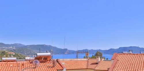 a view of the roof of a building with mountains in the background at Kas Athena Hotel in Kas