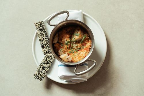 a pot of food on a plate on a table at The Ritz-Carlton, Herzliya in Herzelia 