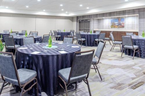 a conference room with tables and chairs and a podium at Courtyard by Marriott Yonkers Westchester County in Yonkers
