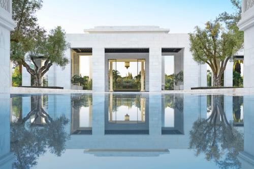 a house with a pool of water in front of it at The Ritz-Carlton Rabat, Dar Es Salam in Rabat