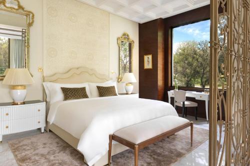 a bedroom with a large white bed and a desk at The Ritz-Carlton Rabat, Dar Es Salam in Rabat