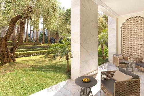 a patio with a table and chairs and a yard at The Ritz-Carlton Rabat, Dar Es Salam in Rabat