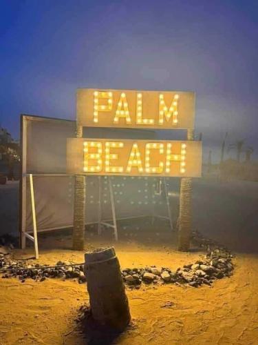 a sign that says ball beater on the beach at Lasirina palm beach for families only in Ain Sokhna