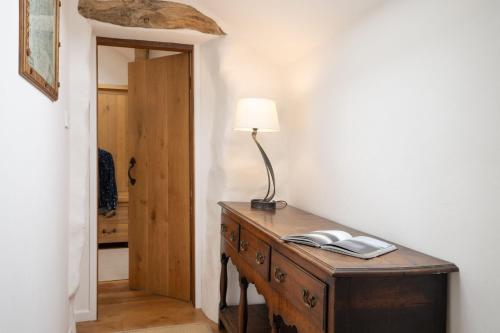 a lamp on a wooden desk in a room at Panoramic Views & Spacious Living by LetMeStay in Grasmere