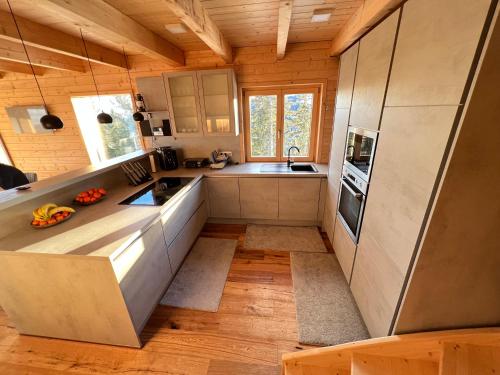 a kitchen with wooden walls and wooden floors at Chalet Theresa in Bad Sankt Leonhard im Lavanttal