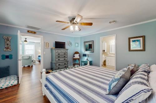 a bedroom with a bed and a ceiling fan at Gone Intracoastal in Ocean Isle Beach