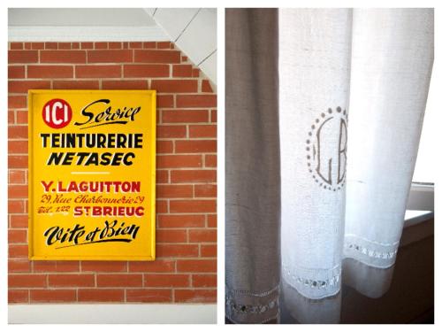 a sign that is next to a brick wall with a curtain at Les gites de Kerégal - la cabane de Charlotte in Plouha