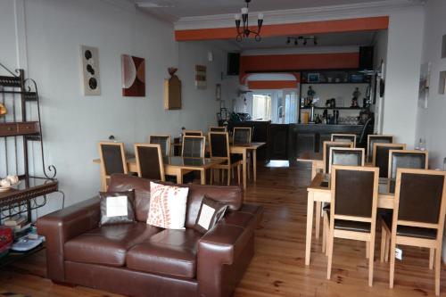 a living room with a couch and a table and chairs at Shananagens Guesthouse in Blackpool
