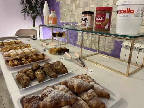 a table with many different types of pastries on it at Hotel Villa Rosa in Porto Azzurro