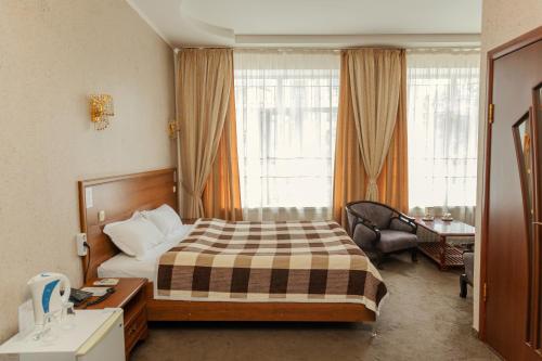 a hotel room with a bed and a desk at Ajour in Almaty