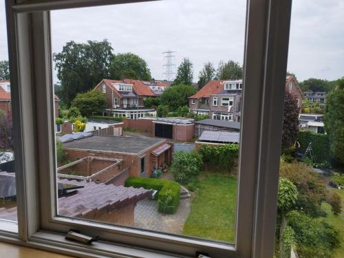 a view of a city from a window at Tranquil Retreat - Free American Pancake-Guest House in Arnhem