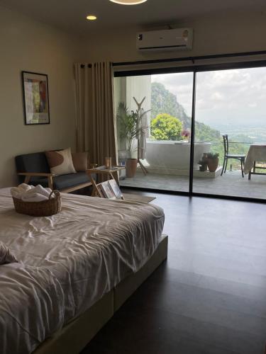 a bedroom with a bed and a view of a patio at Layo Homestay in Ban Pha Mi