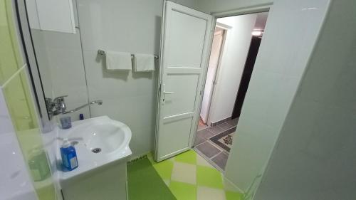 a white bathroom with a shower and a sink at D,apartman' ulica pušća 51, 51513 Omišalj in Omišalj