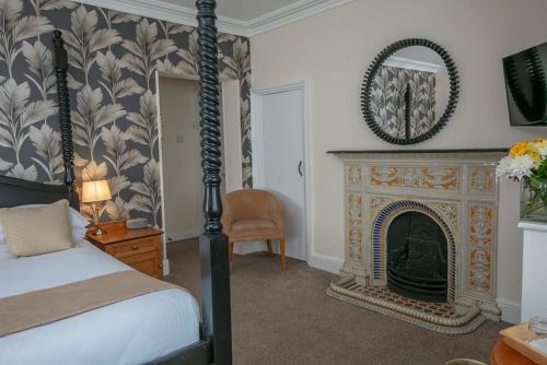 a bedroom with a bed and a fireplace at Best Western Valley Hotel in Ironbridge