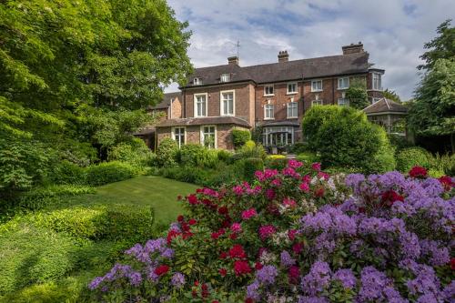 a large house with flowers in front of it at Best Western Valley Hotel in Ironbridge