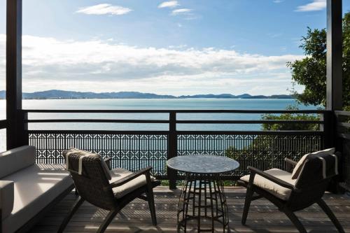 a patio with a table and chairs and a view of the water at The Ritz-Carlton, Langkawi in Pantai Kok