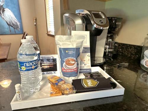 a tray with a bottle of water and other items on a counter at Lady of the Lake in Chapin