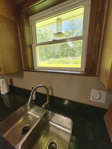 a kitchen with a sink and a window at Lady of the Lake in Chapin