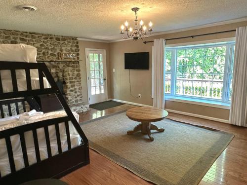 a living room with a bed and a table at Lady of the Lake in Chapin