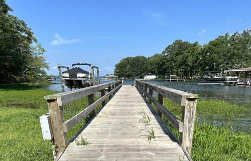 a wooden dock with a boat on the water at Lady of the Lake in Chapin