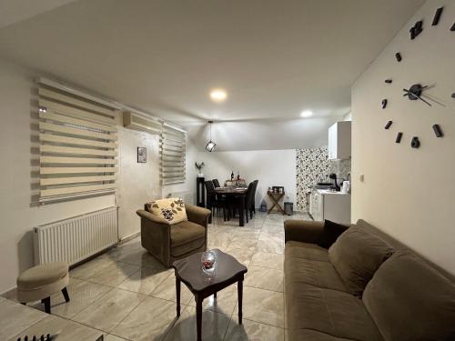 a living room with a couch and a table at Apartman Gold LUX in Surčin