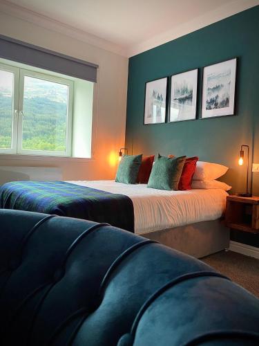 a bedroom with two beds and two windows at Lochside Guest House in Arrochar