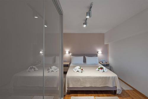 a bedroom with a bed and a glass shower at Luxury Beachfront Apartment in Kalamata Modern, Spacious & Sea View Balcony in Kalamata